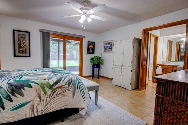 a bedroom with a large bed and a chandelier