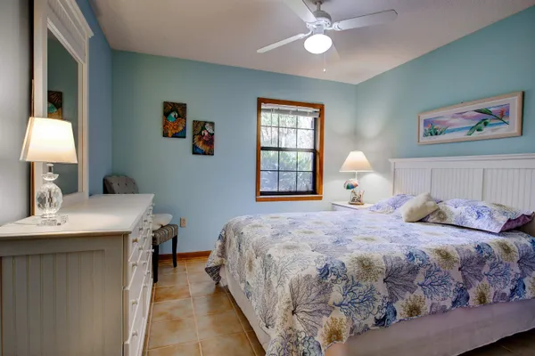 a bedroom with a bed and a table