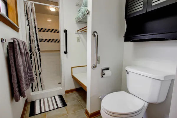 a white toilet sitting next to a bathroom sink