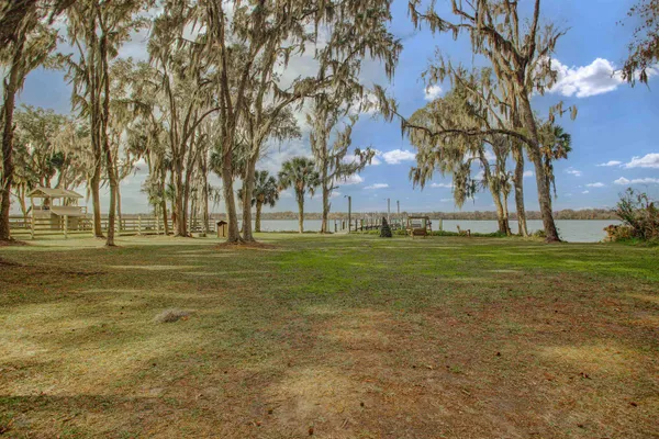 a view of a balcony with wooden floor and ocean view