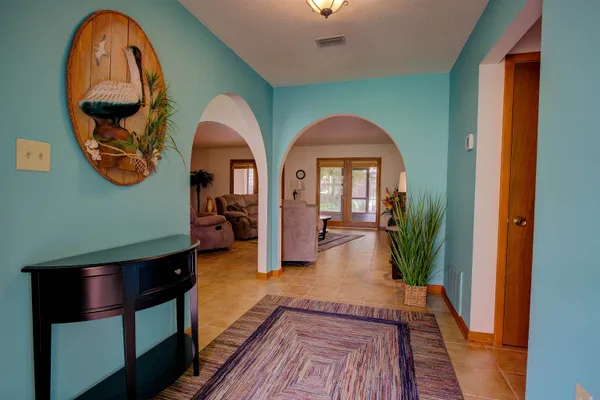 a view of a livingroom with furniture wooden floor and a rug