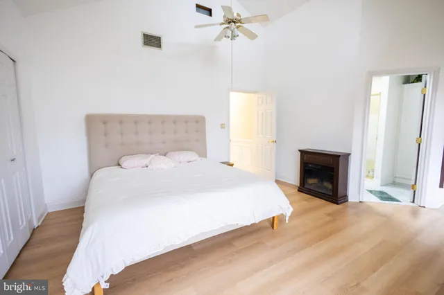 a spacious bedroom with a bed and a fireplace