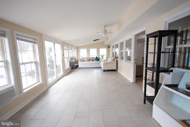 a living room with furniture and large windows