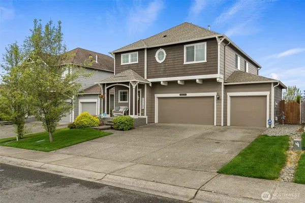 a front view of a house with a yard and garage