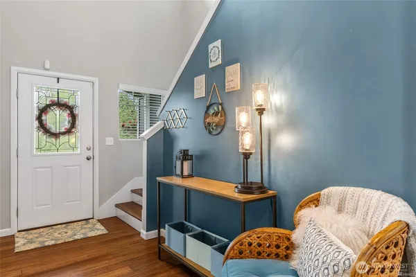 a bedroom with two beds and wooden floor