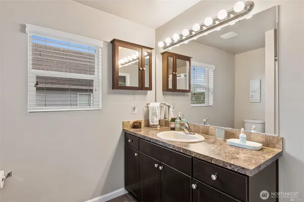 a bathroom with a sink a vanity and a mirror