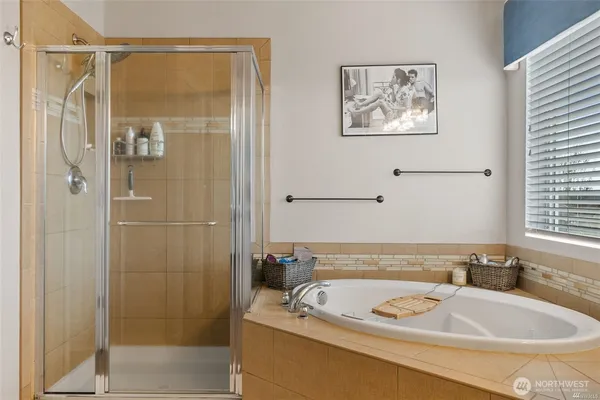 a bathroom with a tub and shower