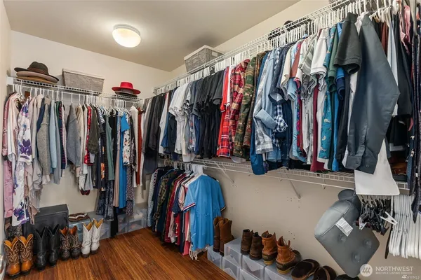 a view of walk in closet with clothes