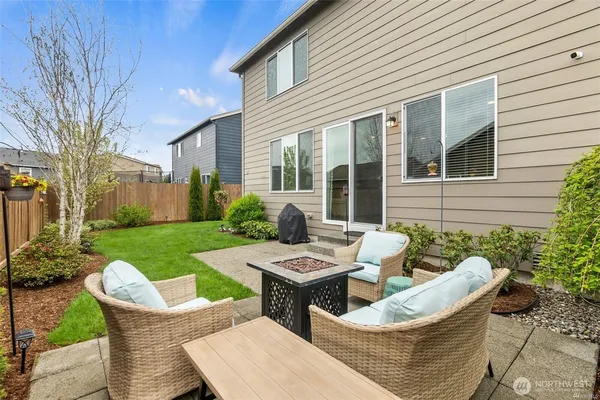 a view of a patio with couches chairs and a yard