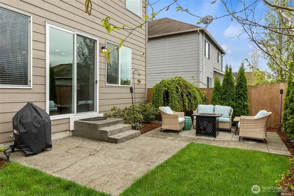 a view of a patio with couches table and chairs and potted plants