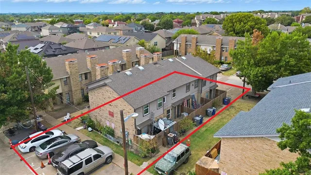 an aerial view of a houses with street