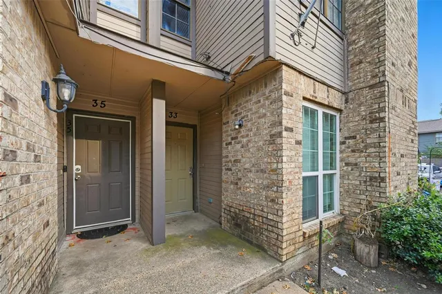a view of entryway with brick walls