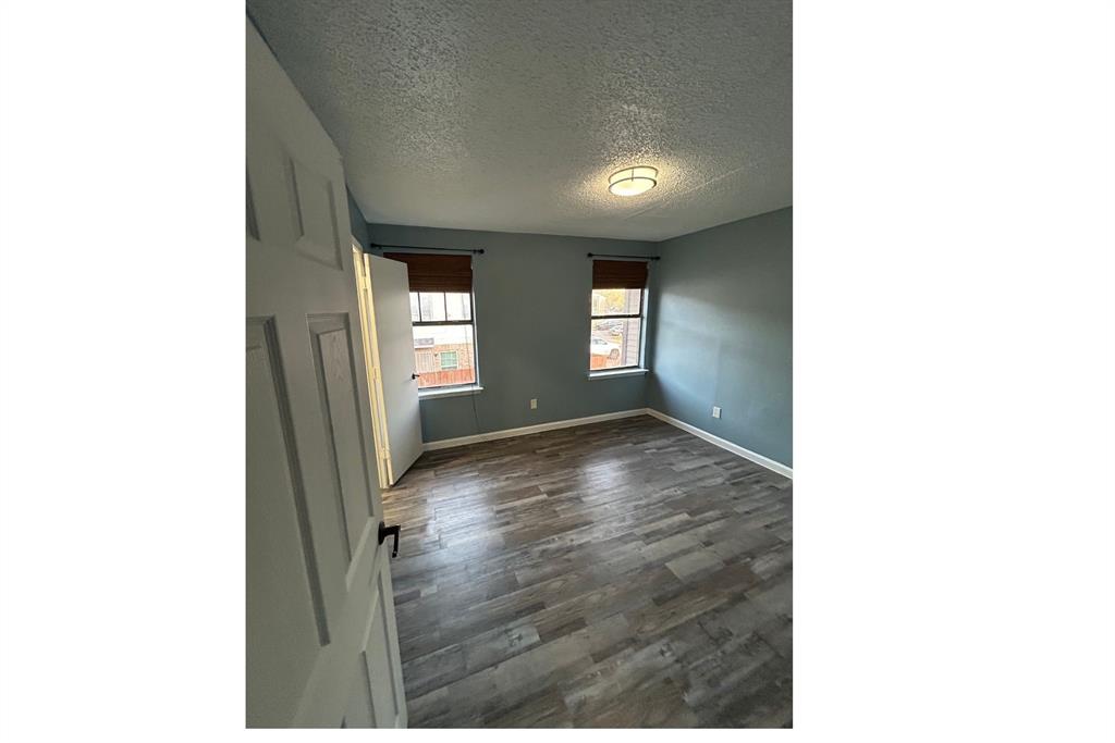 8001 Rothington Road, Unit 3137 Dallas, TX 75227 - Photo 17 of 38 a view of an empty room with window and wooden floor
