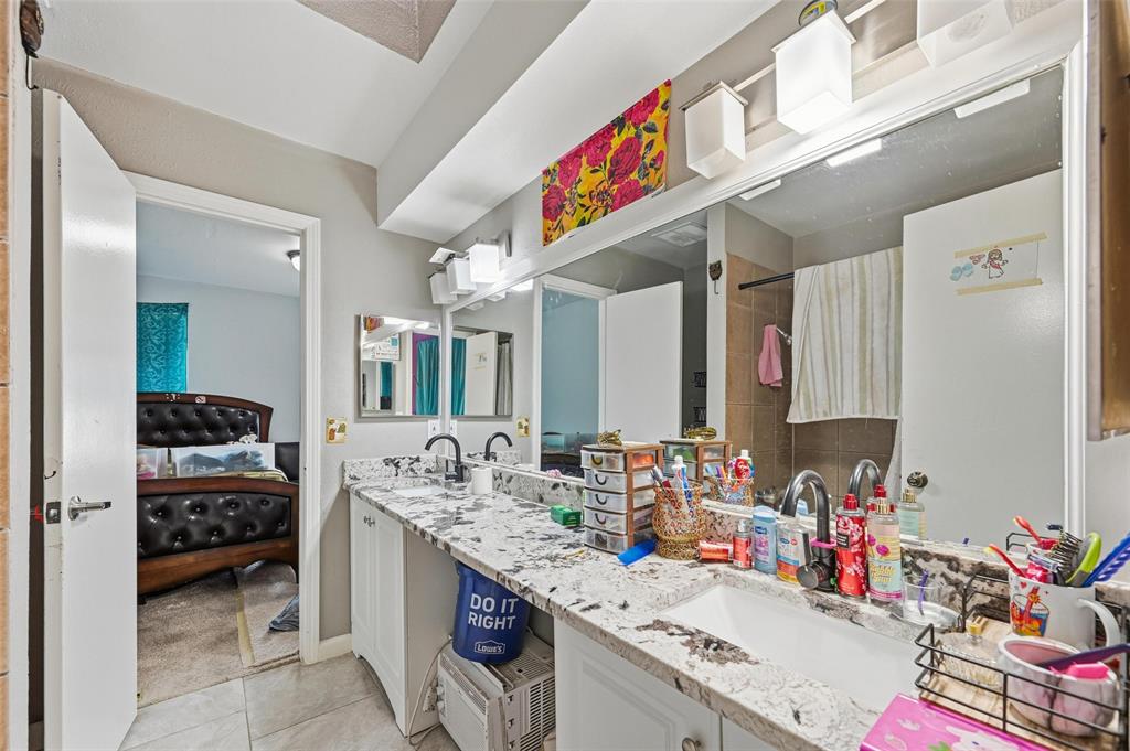 8001 Rothington Road, Unit 3137 Dallas, TX 75227 - Photo 25 of 38 a bathroom with sink and a mirror