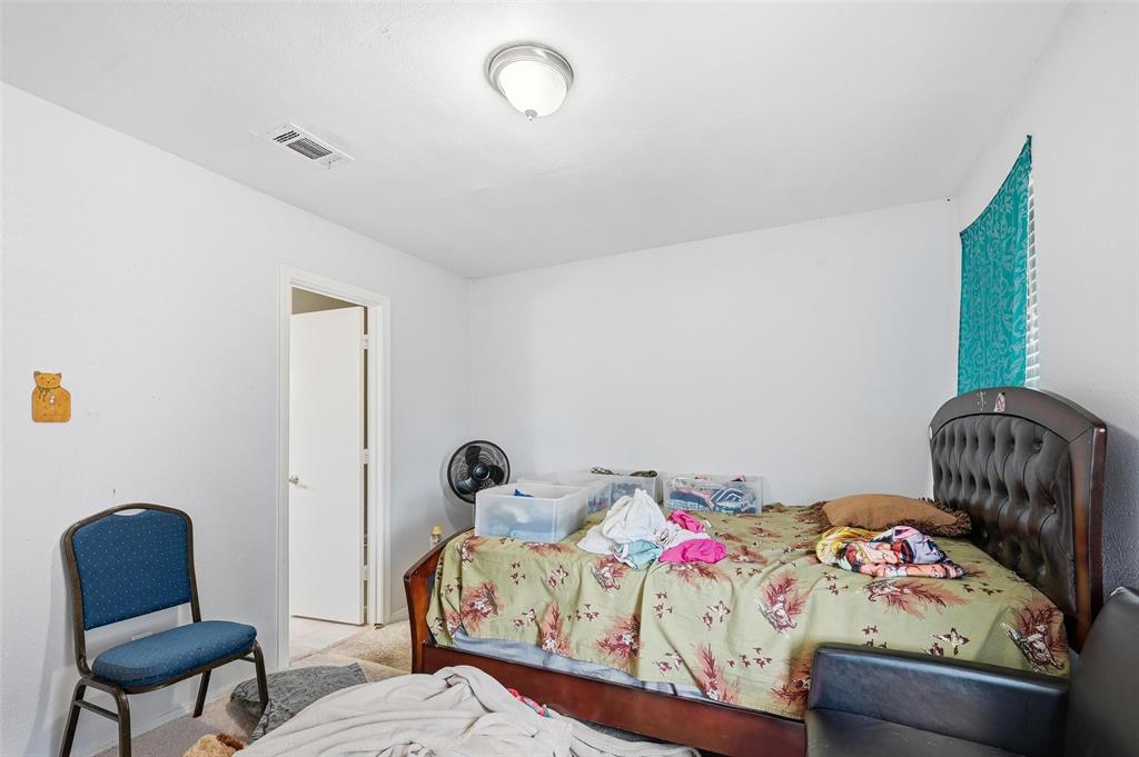 8001 Rothington Road, Unit 3137 Dallas, TX 75227 - Photo 27 of 38 a bedroom with a bed a couch and a chair