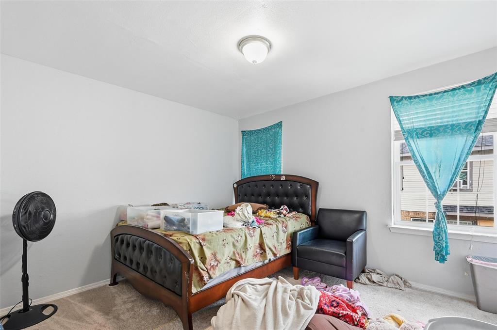 8001 Rothington Road, Unit 3137 Dallas, TX 75227 - Photo 28 of 38 a bedroom with a bed and a chandelier