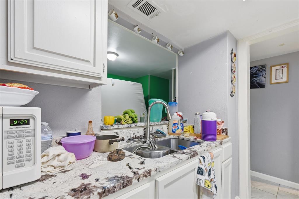 8001 Rothington Road, Unit 3137 Dallas, TX 75227 - Photo 29 of 38 a bathroom with a sink and a mirror