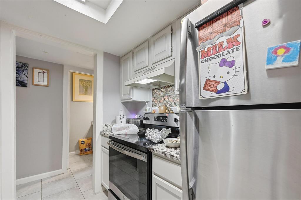 8001 Rothington Road, Unit 3137 Dallas, TX 75227 - Photo 30 of 38 a kitchen with stainless steel appliances granite countertop a stove and a refrigerator