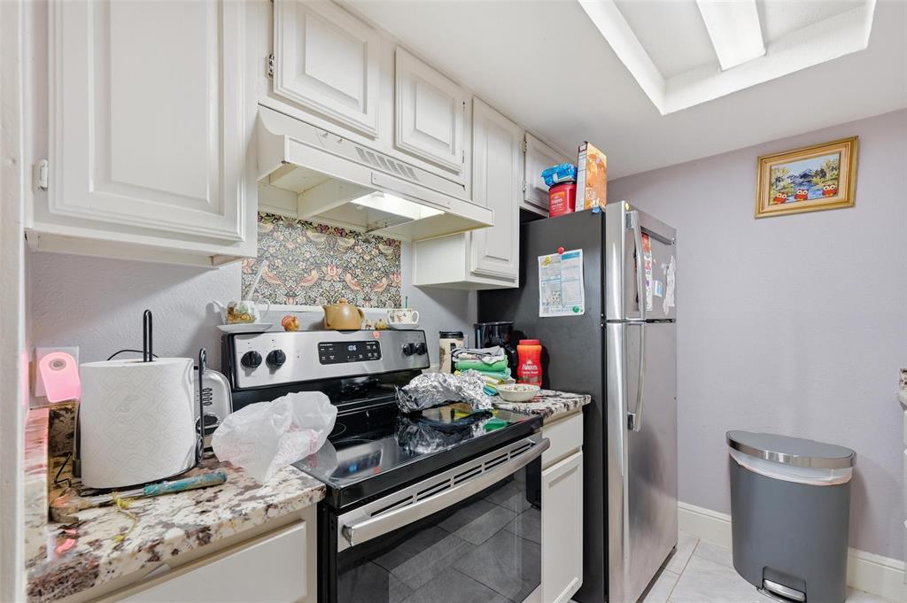 8001 Rothington Road, Unit 3137 Dallas, TX 75227 - Photo 36 of 38 a kitchen with stainless steel appliances granite countertop a refrigerator and a stove