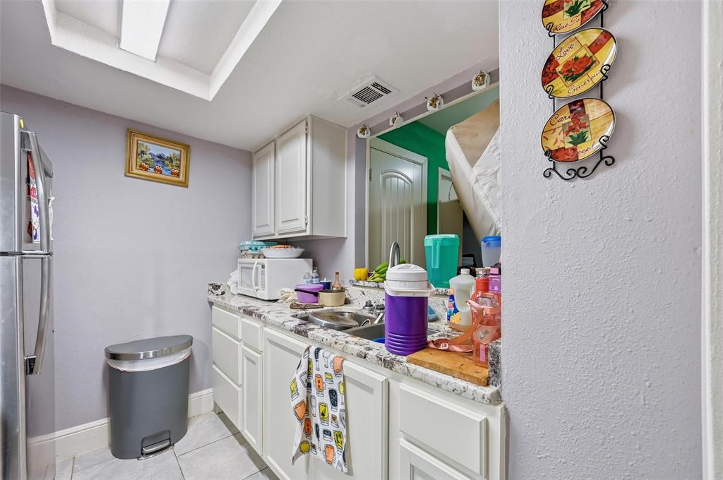 8001 Rothington Road, Unit 3137 Dallas, TX 75227 - Photo 37 of 38 a bathroom with a sink and a mirror