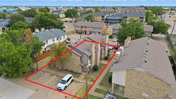 an aerial view of a house with a yard
