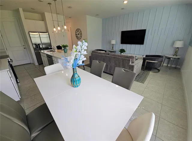 a room with lots of frames and paintings on the wall