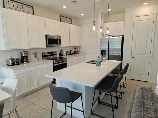 a view of a hallway with entryway a chandelier and front door