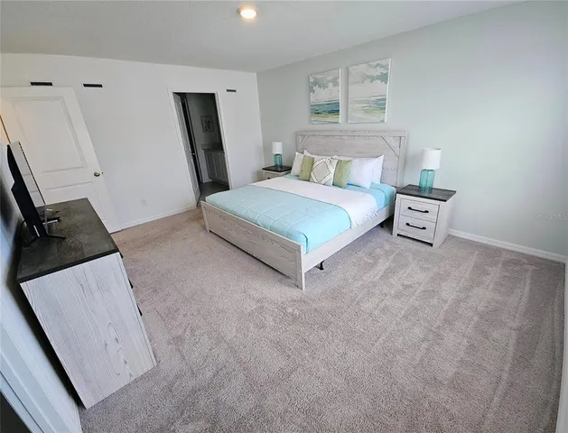 a white toilet sitting next to a white wall