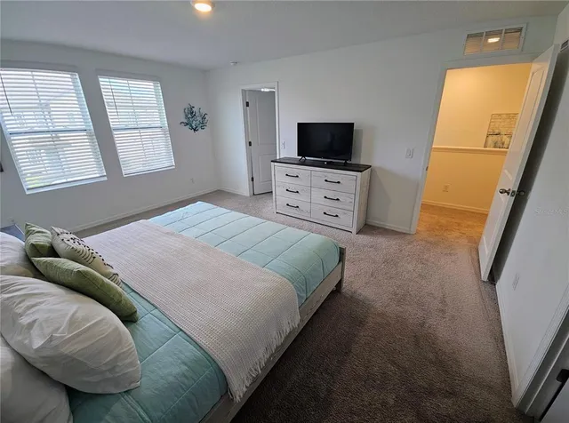a bedroom with furniture and a window