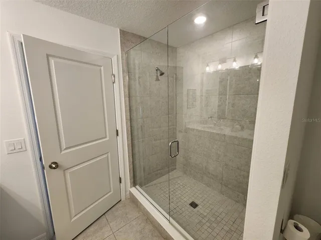 a bathroom with a sink mirror and vanity