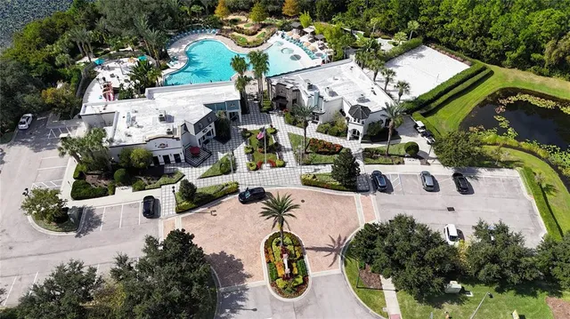 a view of house with swimming pool and sitting area