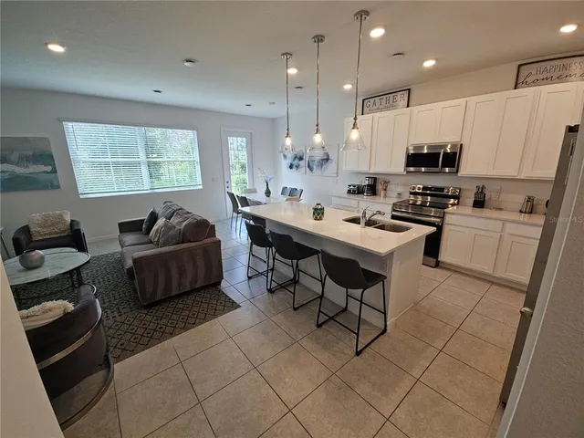 a living room with furniture and a dining table