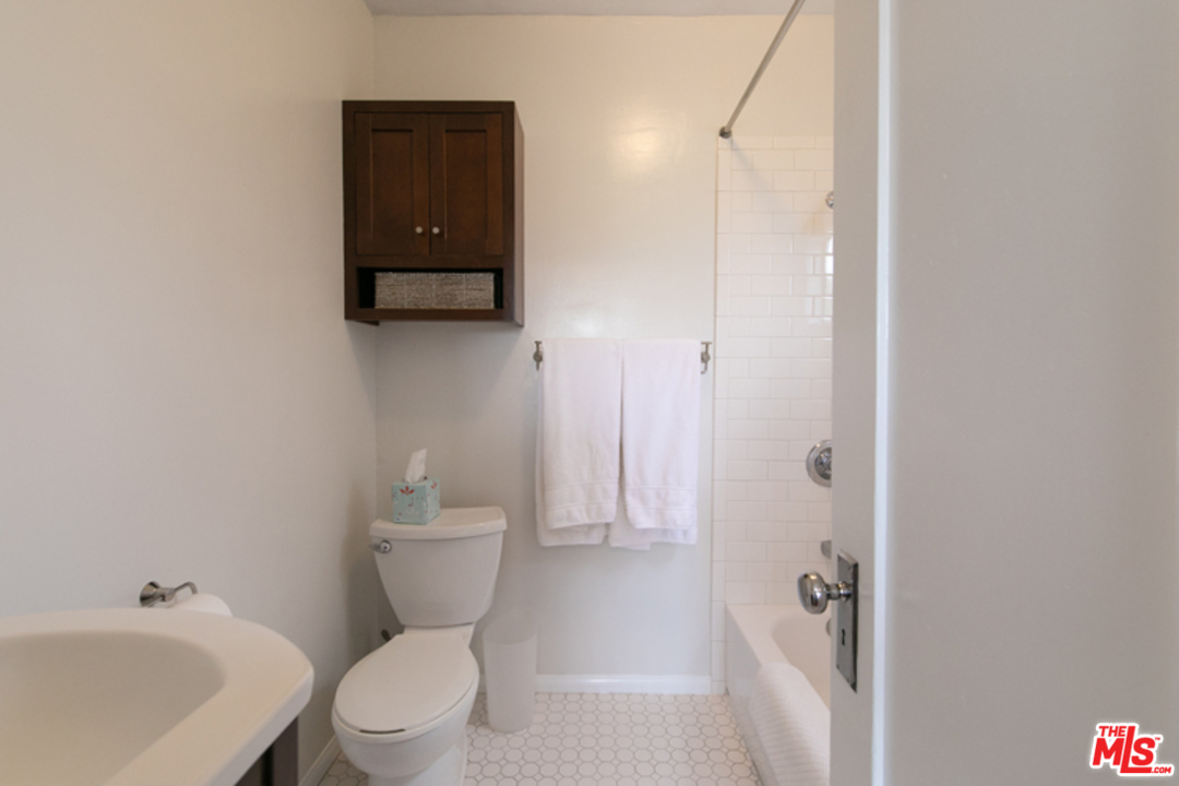 5122 Raphael Street Los Angeles, CA 90042 - Photo 11 of 37 a bathroom with a toilet a sink and mirror