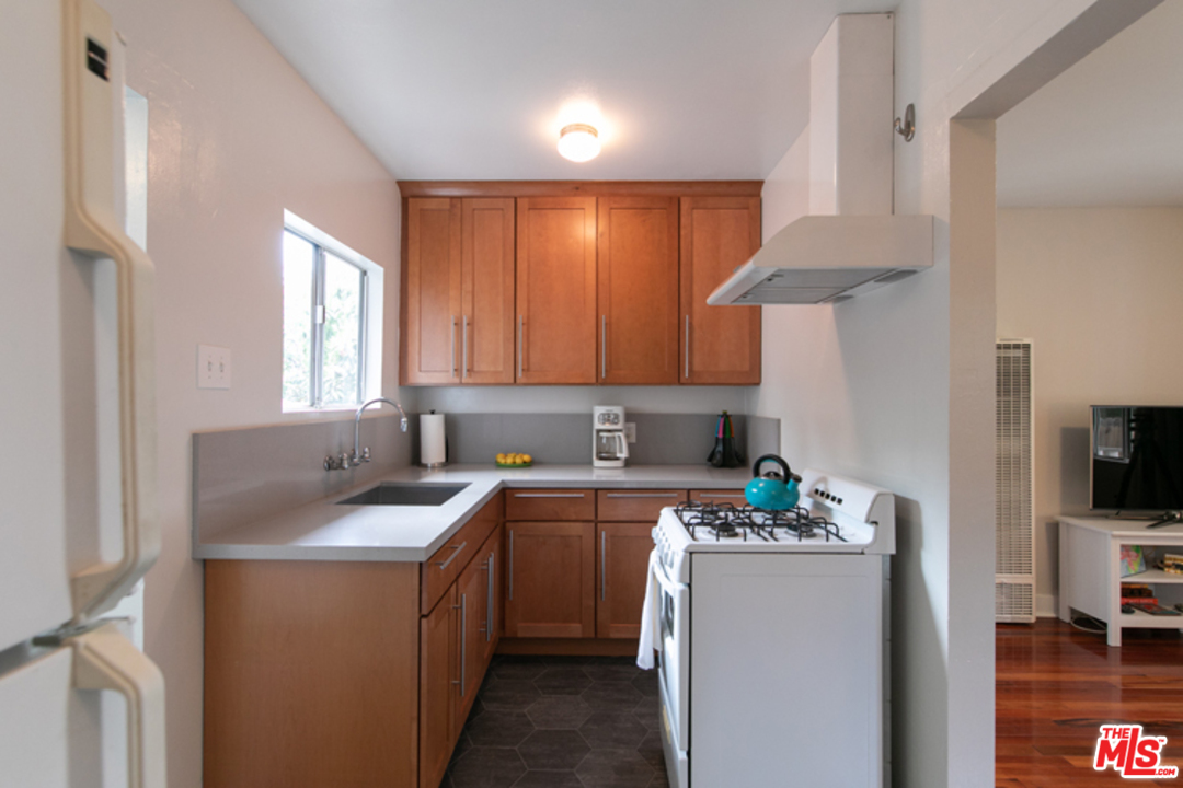 5122 Raphael Street Los Angeles, CA 90042 - Photo 14 of 37 a kitchen with a sink cabinets and a window