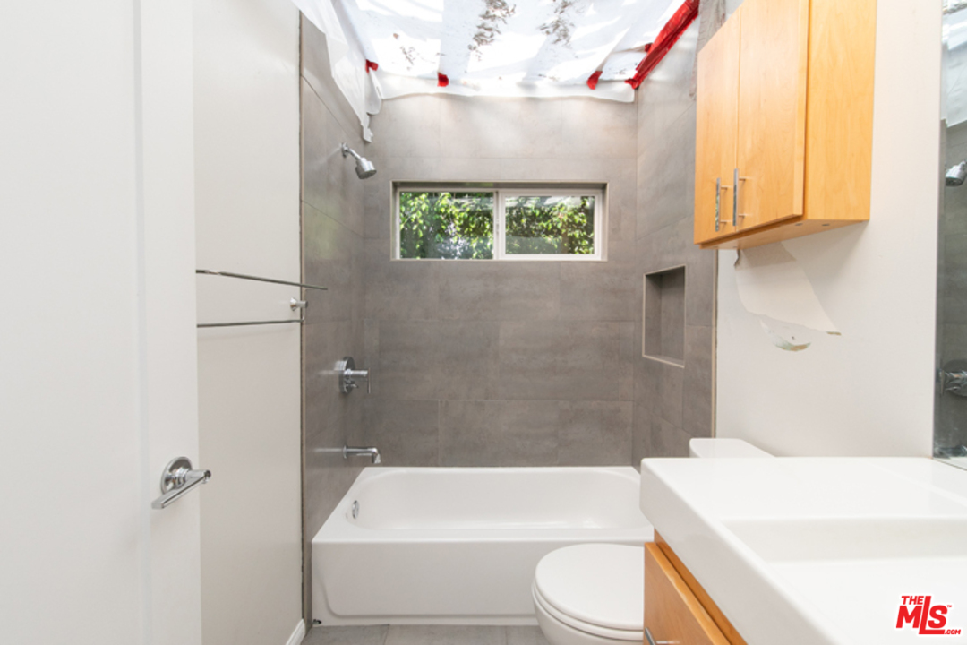 5122 Raphael Street Los Angeles, CA 90042 - Photo 27 of 37 a bathroom with a sink a toilet and bathtub
