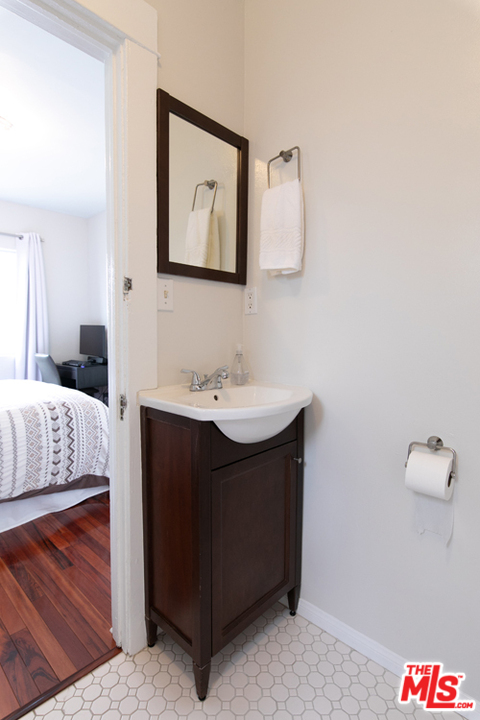 5122 Raphael Street Los Angeles, CA 90042 - Photo 10 of 37 a en suite bathroom with a sink vanity and mirror