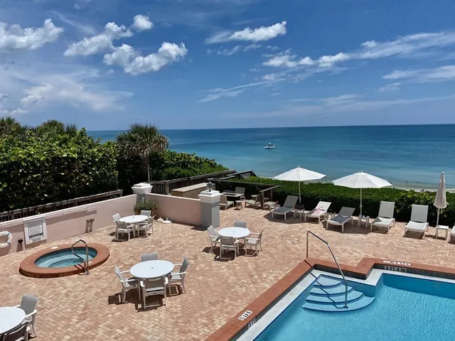 an aerial view of a houses with a yard