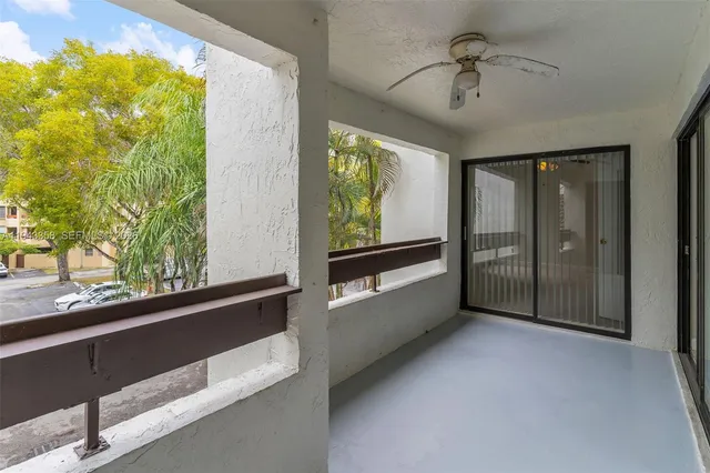 a view of hallway with a large window and chandelier