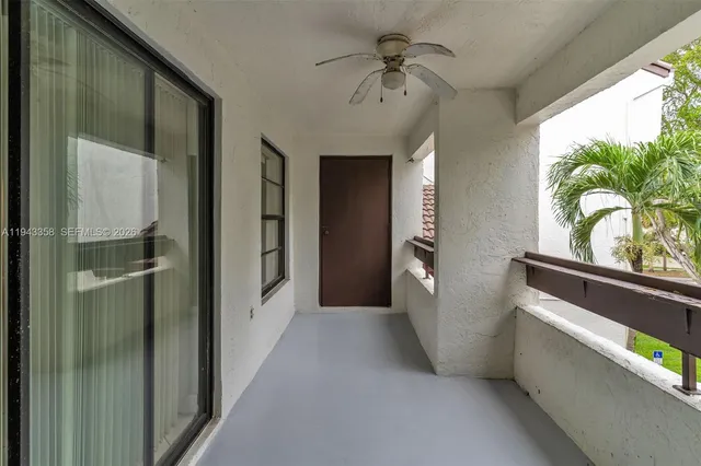 a view of hallway with window and wooden floor
