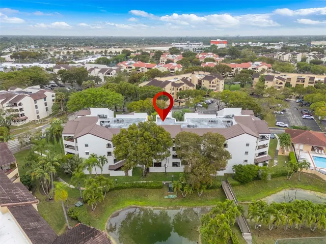 an aerial view of residential houses with outdoor space and ocean view