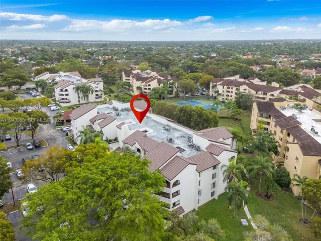an aerial view of residential houses with outdoor space and river