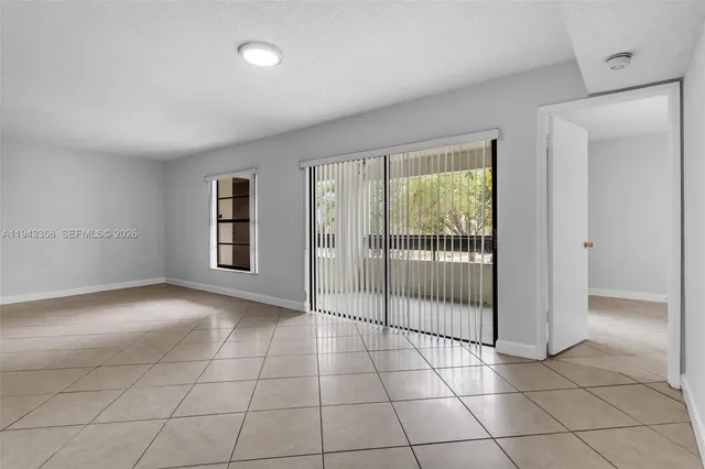 a view of a livingroom with a chandelier and glass door
