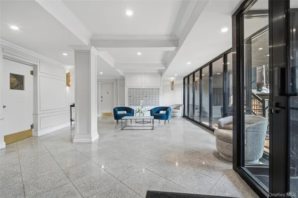 a view of a hallway with dining area and chandelier