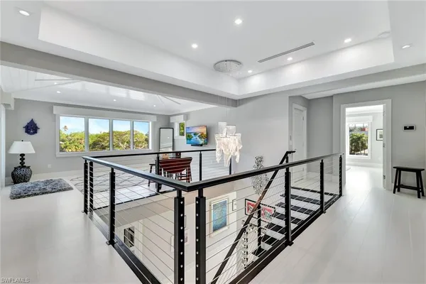 a view of a hallway with livingroom and furniture