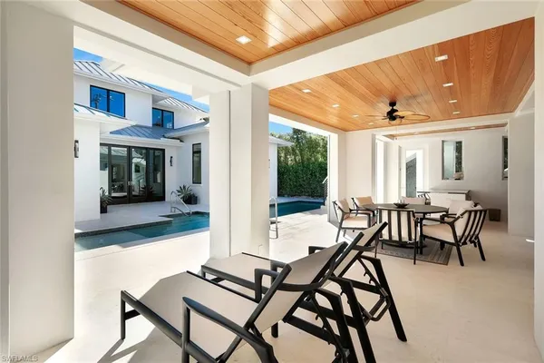 a kitchen with a table chairs and a window