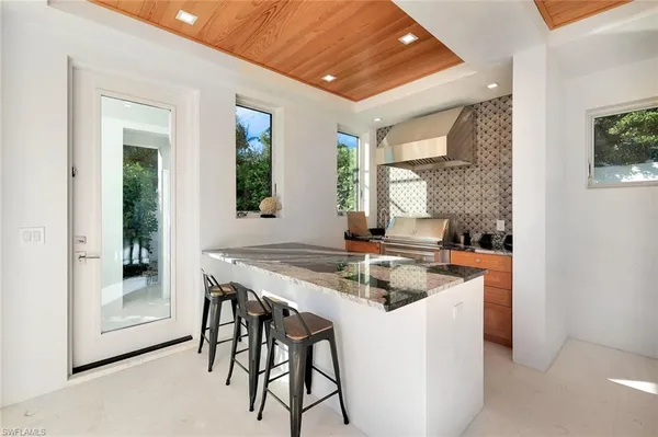 a view of a dining room with furniture and a chandelier