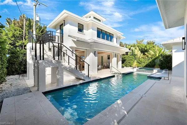 a view of a patio with table and chairs and potted plants