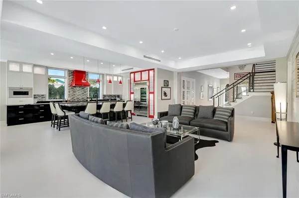 a living room with lots of furniture and kitchen view