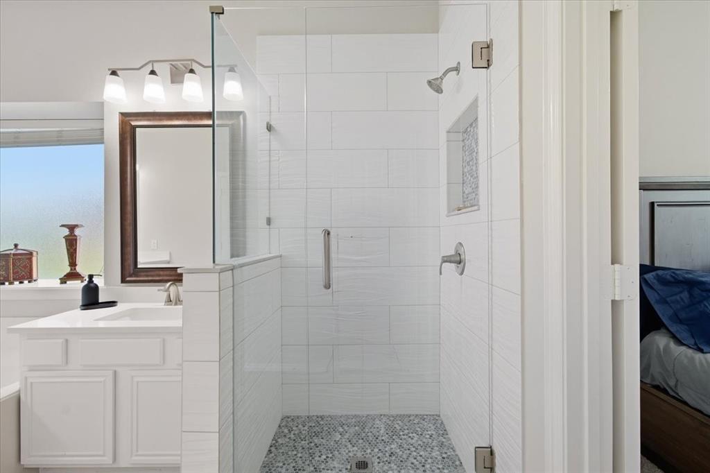409 Springtree Road Lake Dallas, TX 75065 - Photo 29 of 40 White shaker vanity with a single basin sink and a stone countertop