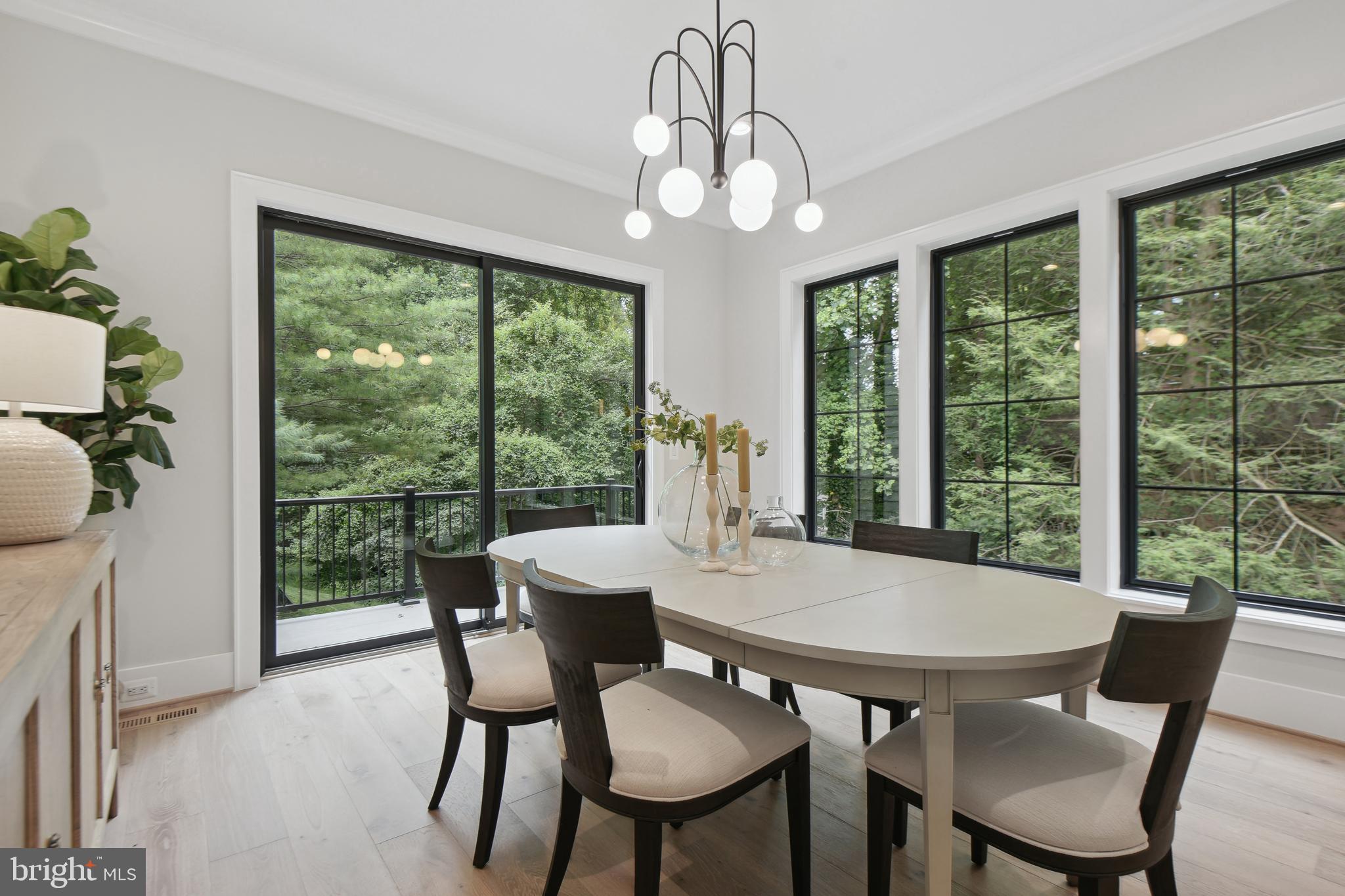6523 Old Chesterbrook Road McLean, VA 22101 - Photo 6 of 17 a view of a dining room with furniture large windows and wooden floor